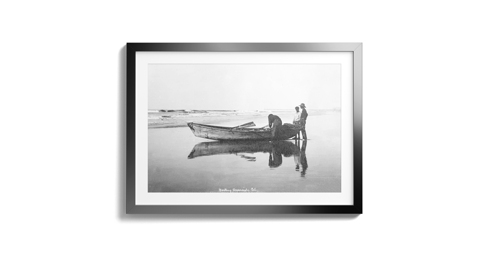 Frames-Mockup-Copy-of-2-20--Men-Next-to-skiff-on-Beach-by-Wisconsin-Street-Pier-in-Background2-
